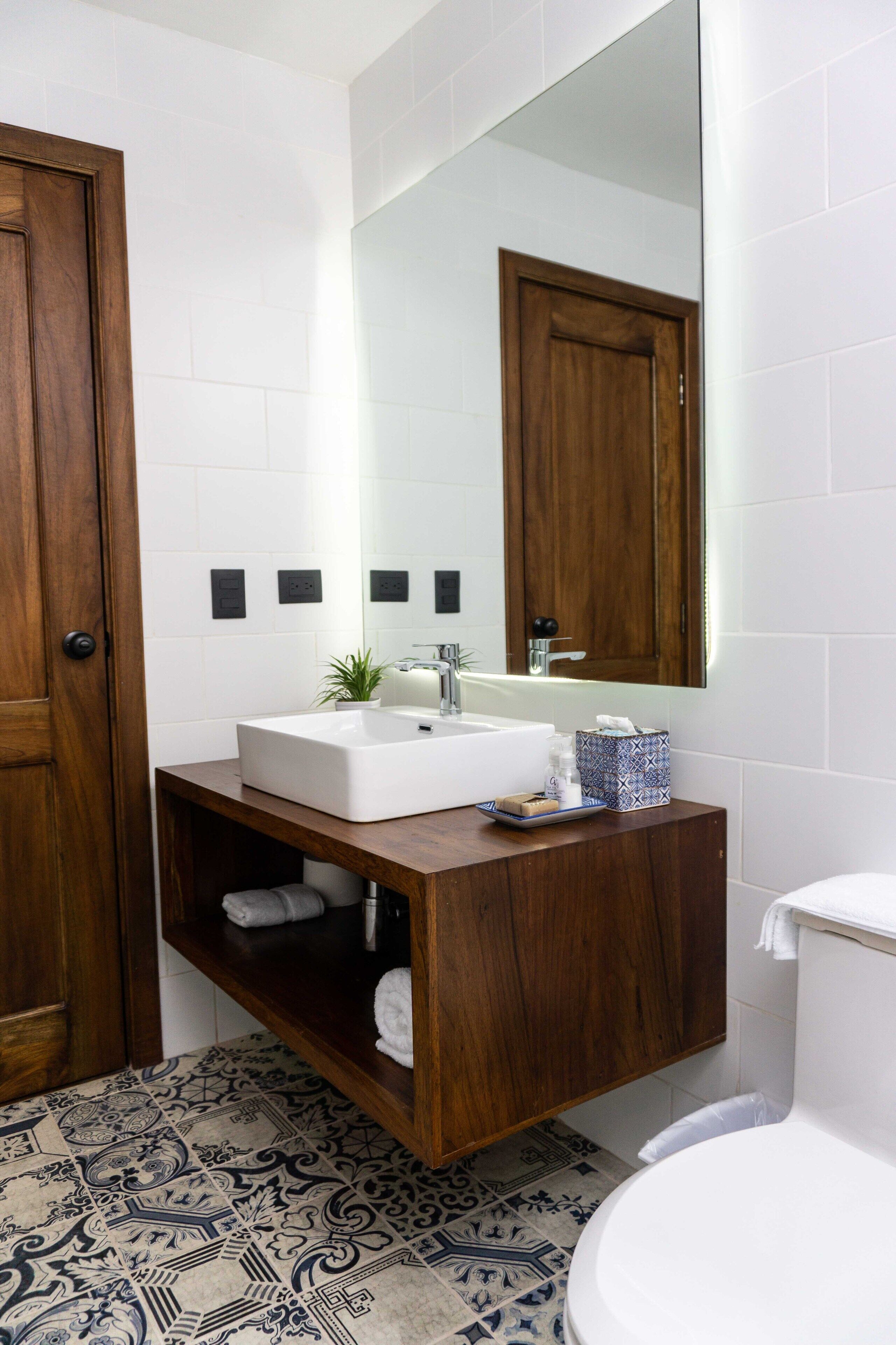 deluxe quadruple room | bathroom | hair dryer, towels, soap, shampoo