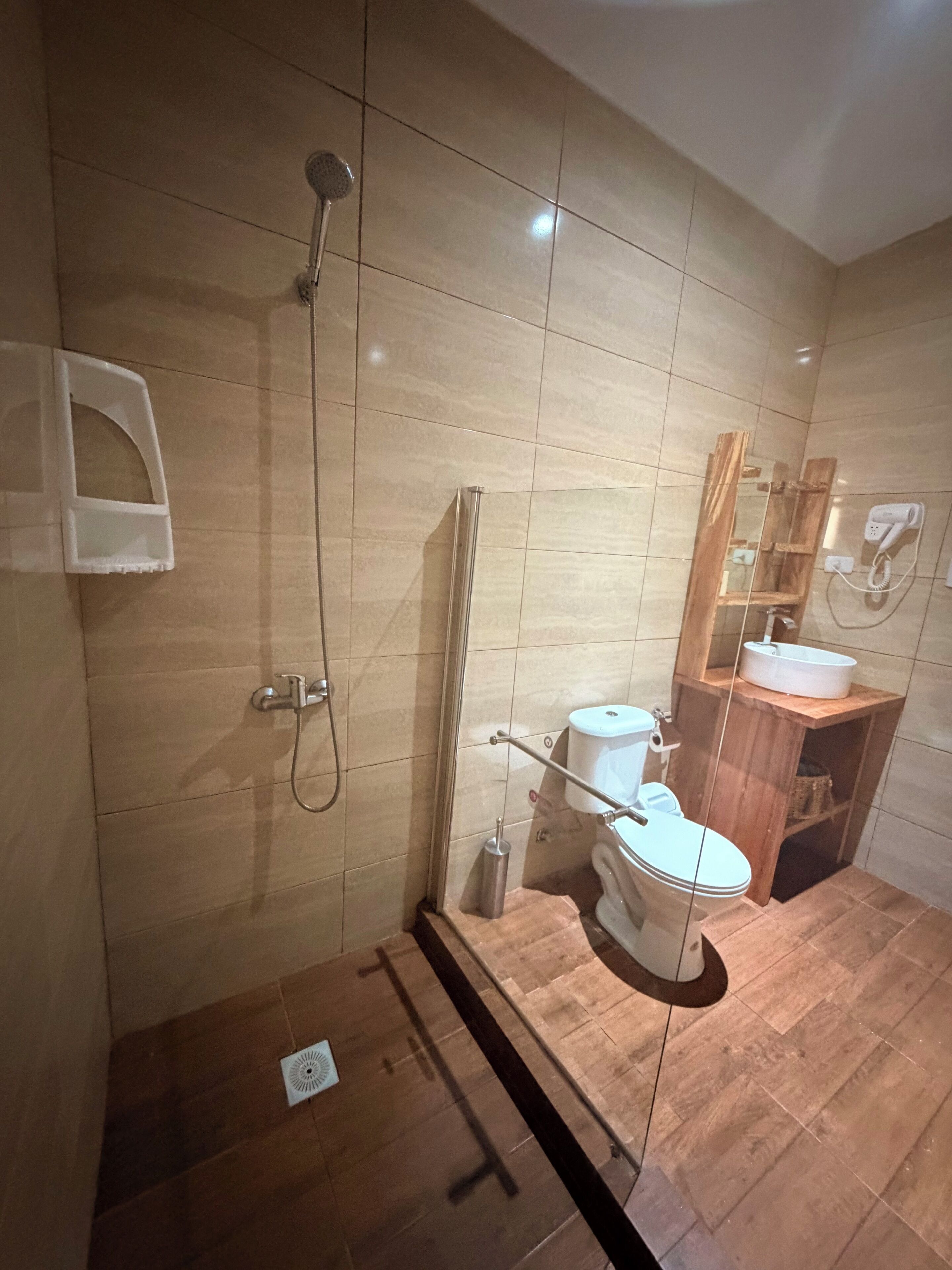 A bathroom with a shower, toilet, and sink.