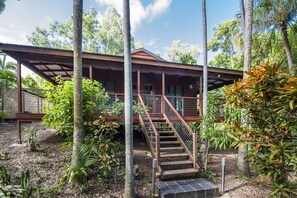 A wooden building with a covered porch and a staircase leading to the entrance. - Magnetic Effect, 36 Mirimar Cres-BOM (Arcadia)