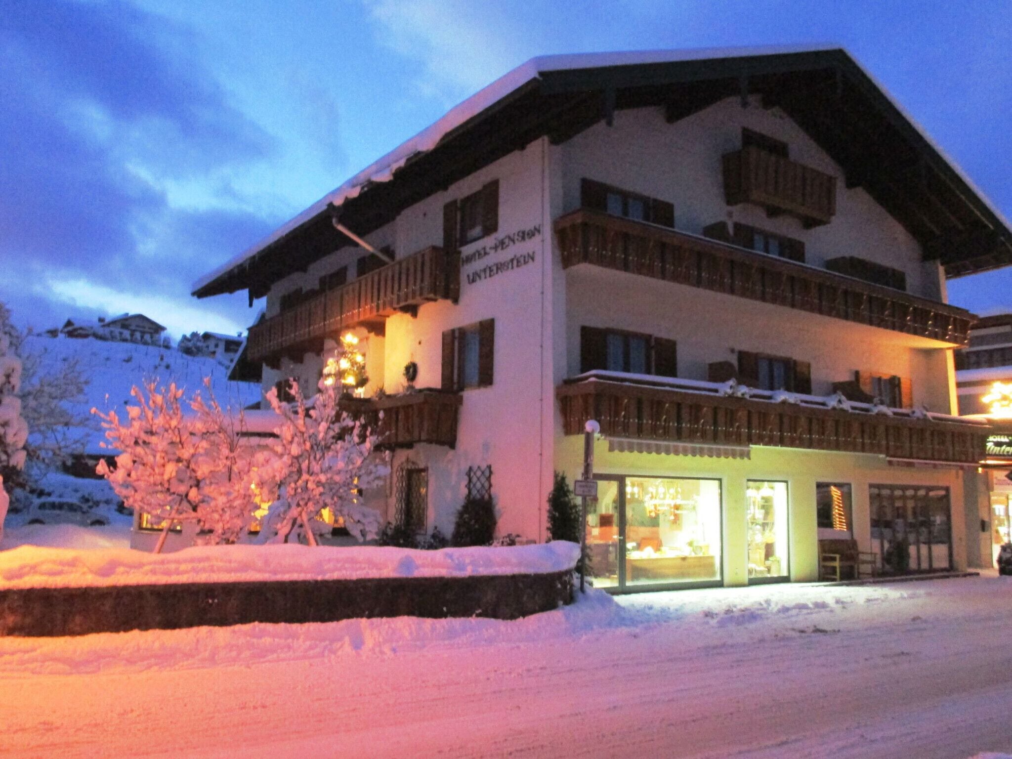 A multi-story hotel with a snow-covered exterior and balconies.