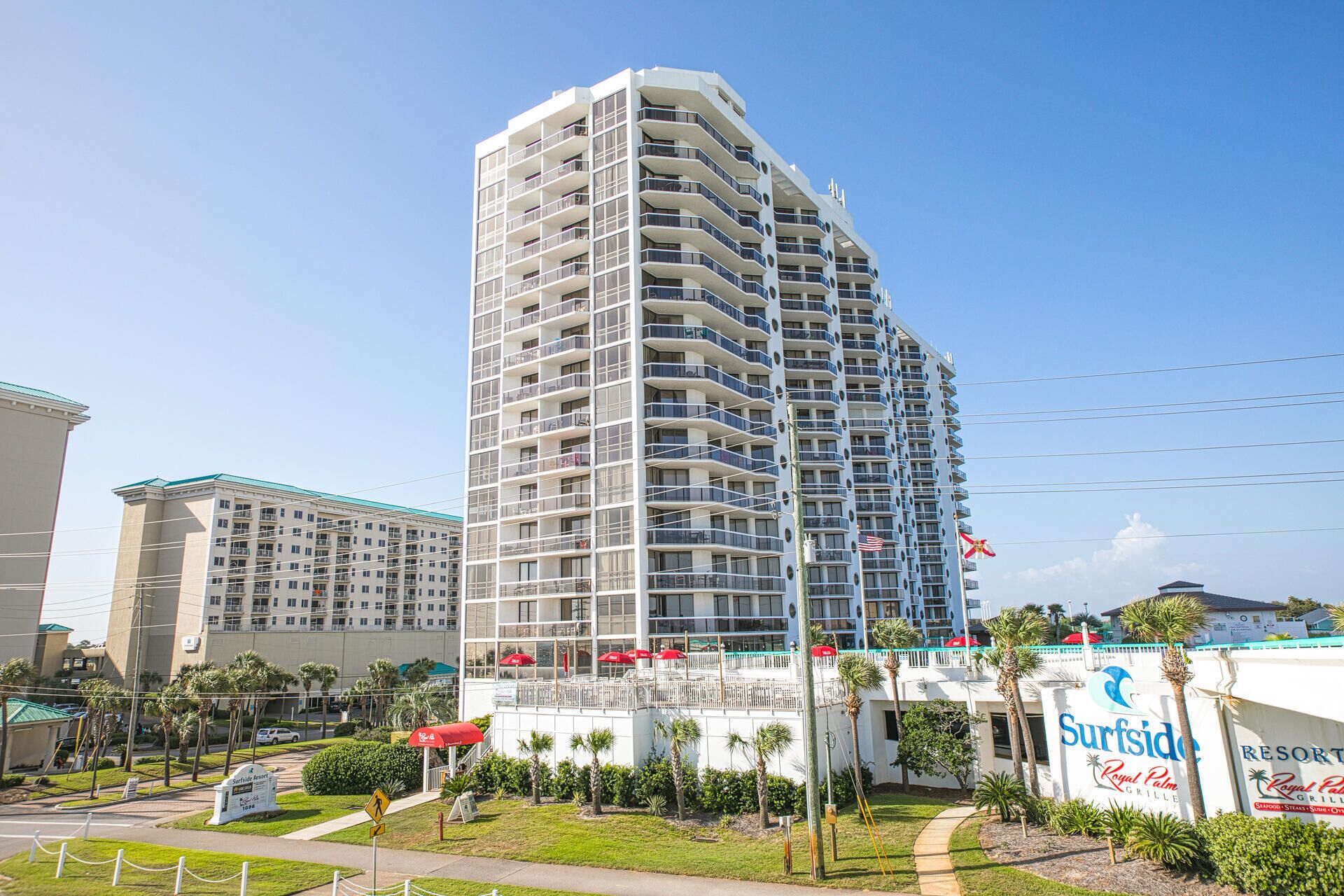 A tall, multi-story hotel with balconies and a sign for Surfside Resort.