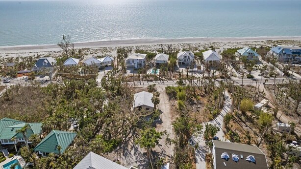 A beachfront property with multiple houses, a sandy beach, and the ocean in the background. - The Bungalow - Captiva Beach Cottage on Turner Beach (Captiva)