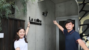 Rakennuksen sisäänkäynti, jonka yläpuolella on kyltti, jossa lukee: ”La colline SHIBUYA”.