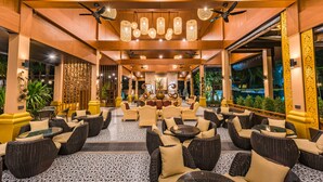 A spacious indoor area with wicker furniture, ceiling fans, and decorative lighting. - Princess Kamala Beachfront Hotel (Kamala)