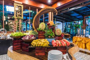 A buffet with various fruits and vegetables, including bananas, watermelon, and pineapple. - Princess Kamala Beachfront Hotel (Kamala)