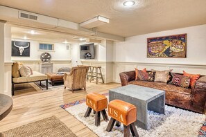 A spacious living area with a sofa set, a coffee table, and a chair with 'USA' on it.