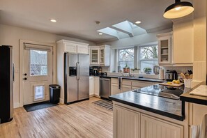 Coffee/tea maker, fridge, cookware/dishes/utensils