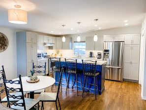 Enjoy meals at the central island with bar stools, a refrigerator, and a coffee maker.