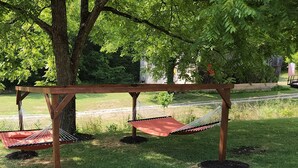 A hammock setup under a tree in a park. - The BirdDog Farm Cabin #1        (Dixon Springs)
