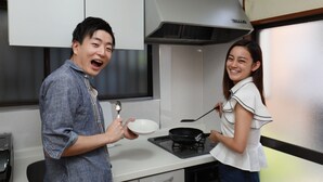 A modern kitchen with white cabinets, a stainless steel range hood, and a gas stove. - IBASHO Roppongi (Tokyo)
