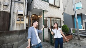 A two-story building with a brick facade, a balcony, and a small garden area. - IBASHO Roppongi (Tokyo)