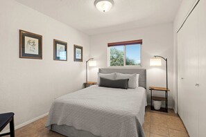 A bedroom with a bed, two bedside tables, a window, and three framed pictures on the wall. - Rustic Cottage Feel, Close to Wineries, Sleeps 6! (Cornville)