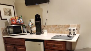 A compact kitchen with a microwave, coffee maker, and a small refrigerator. - The BirdDog Farm Cabin #4    (Dixon Springs)