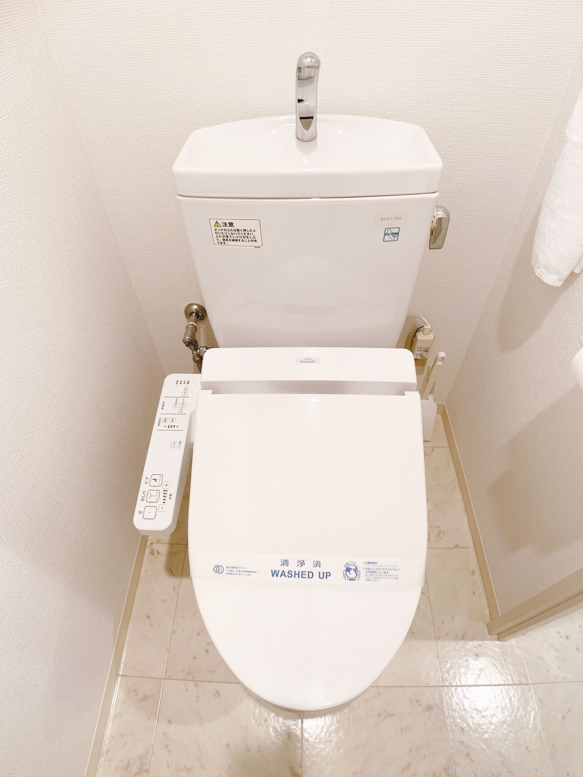 Des toilettes modernes dotées d’un panneau de commande et d’une étiquette indiquant « UTILISÉ ».