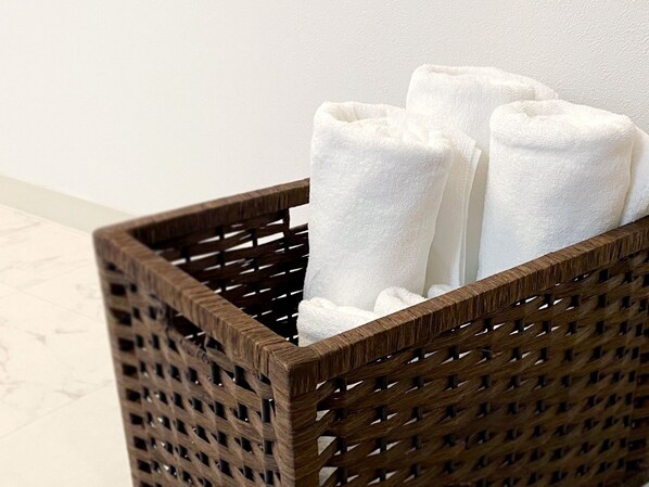 A wicker basket with white towels.
