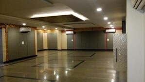 A spacious, well-lit indoor area with multiple enclosed spaces, likely restrooms, and a polished floor. - Gulabi Bagh Resort (A unit of Sarvmangla Garden) (Jaipur)