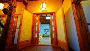 A traditional Japanese interior with wooden doors and a lantern. - Jeonju Happy Maru Hanok (Jeonju)