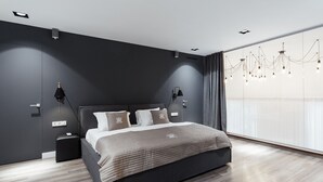 A modern bedroom with a large bed, dark walls, and a large window with curtains. - Royal Apartment Primorskiy bulvar 1 (Odesa)