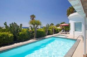 A heated pool, pool loungers