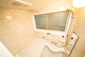 A bathroom with a shower, a sink, and a window. - OneHome Shinn-Nakano (Tokyo)