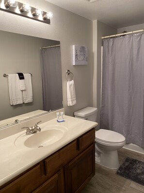 Combined shower/tub, hair dryer, towels, soap