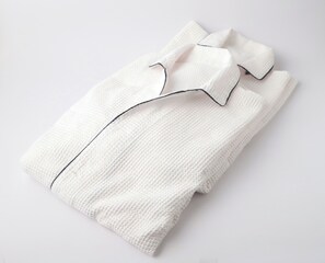 A neatly folded white shirt with a black collar and cuffs. - Smile Hotel Shonan Fujisawa (Fujisawa)