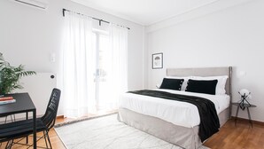 A modern bedroom with a bed, a desk, and a chair. - Spacious 1BD Apartment near HELEXPO Marousi (Marousi)
