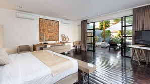 A modern hotel room with a large bed, a desk, and a television. There is a balcony with a view of the outdoors. - Beautiful Villa With Private Pool, Bali Villa 2001 (Seminyak)