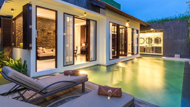 A modern house with a swimming pool, featuring a glass-enclosed dining area, a lounge with outdoor seating, and a well-lit interior. - Beautiful Villa With Private Pool, Bali Villa 2014 (Kerobokan)