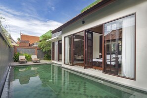 A modern house with a swimming pool, large glass doors, and a view of the backyard. - Beautiful Villa With Private Pool, Bali Villa 2014 (Kerobokan)