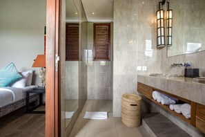 A modern bathroom with a glass-enclosed shower, a large mirror, and a vanity with a marble countertop. - Luxury Villa in Bali near Beach, Bali Villa 2034 (Seminyak)