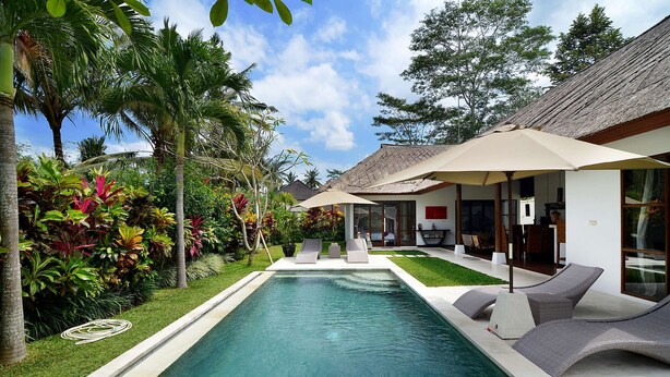 A poolside area with a clear pool, lounge chairs, and a covered seating area with umbrellas. - Luxury Villa in Bali near Beach, Bali Villa 2031 (Ubud)