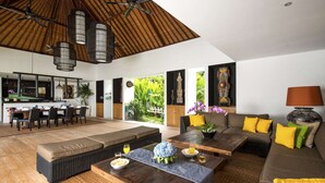 A spacious living area with a dining table, sofas, and a kitchen in the background. - Bali Villa Near the Beach, 2061 (Seminyak)