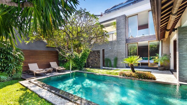 A modern house with a swimming pool, a wooden deck, and a garden with various plants. - Beautiful Villa With Private Pool, Bali Villa 2026 (Seminyak)