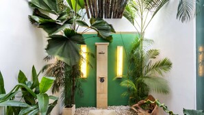 A spa area with a green wall, two vertical light fixtures, a wooden bench, and various plants. - Beautiful Villa With Private Pool, Bali Villa 2026 (Seminyak)