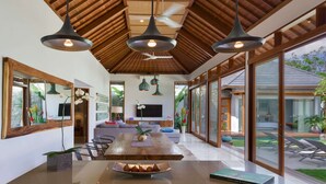 A spacious kitchen with a central island, large windows, and a ceiling fan. - Imagine Your Family Renting a Luxury Holiday Villa Close to Seminyaks Main Attractions, Villa Bali 2043 (Seminyak)