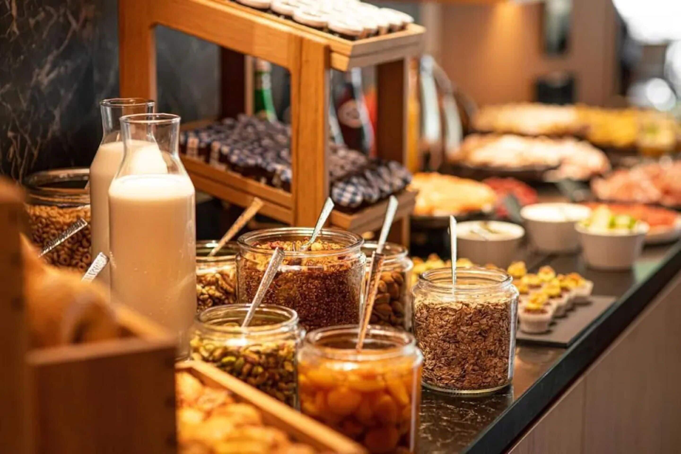A buffet with various food items and a milk bottle.