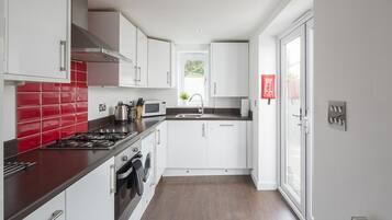 Three-Bedroom House | Private kitchen | Full-size fridge, microwave, oven, stovetop