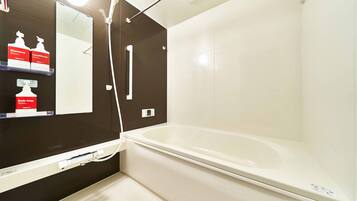 A modern bathroom with a bathtub, a shower, and a vanity with shelves holding toiletries.