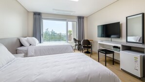 A hotel room with two beds, a desk with a chair, a television, and a small refrigerator. - Swimeong Nolmeong Guesthouse&Pension (Jeju City)