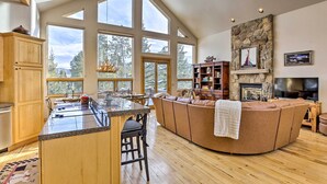 A spacious living area with a large stone fireplace, a built-in TV, and a cozy seating area. - Ski-In/Out Breckenridge Gem w/ Hot Tub! (Breckenridge)