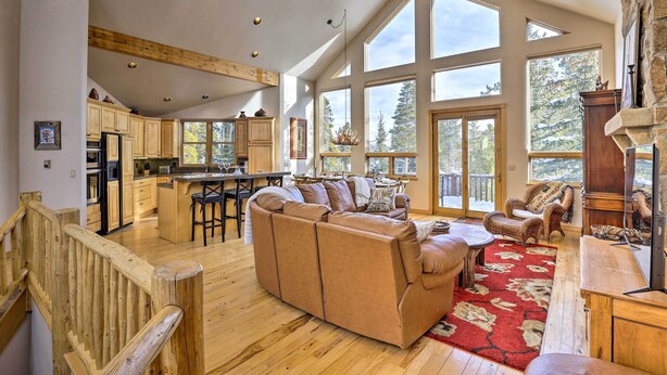 A spacious living area with a large sofa, wooden flooring, and a fireplace. - Ski-In/Out Breckenridge Gem w/ Hot Tub! (Breckenridge)