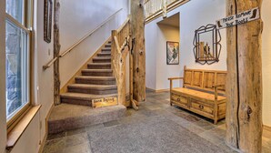 A wooden staircase with a 'Gone Skiing' sign, a 'Please Remove Your Boots' sign, and a bench in a rustic interior. - Ski-In/Out Breckenridge Gem w/ Hot Tub! (Breckenridge)