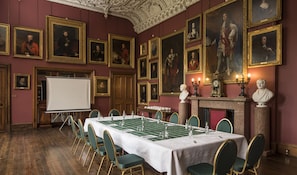 A formal dining room with a long table set for a meal, surrounded by green upholstered chairs. - Thirlestane Castle (Lauder)