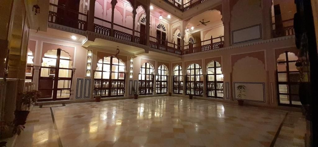 A spacious hall with multiple balconies and large windows.
