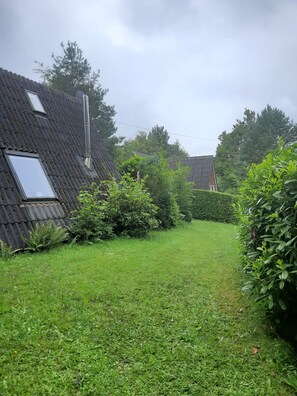 A residential area with a house featuring a sloped roof and a visible chimney. - Idyllic Holiday Home in the Palatinate Forest (Gossersweiler-Stein)