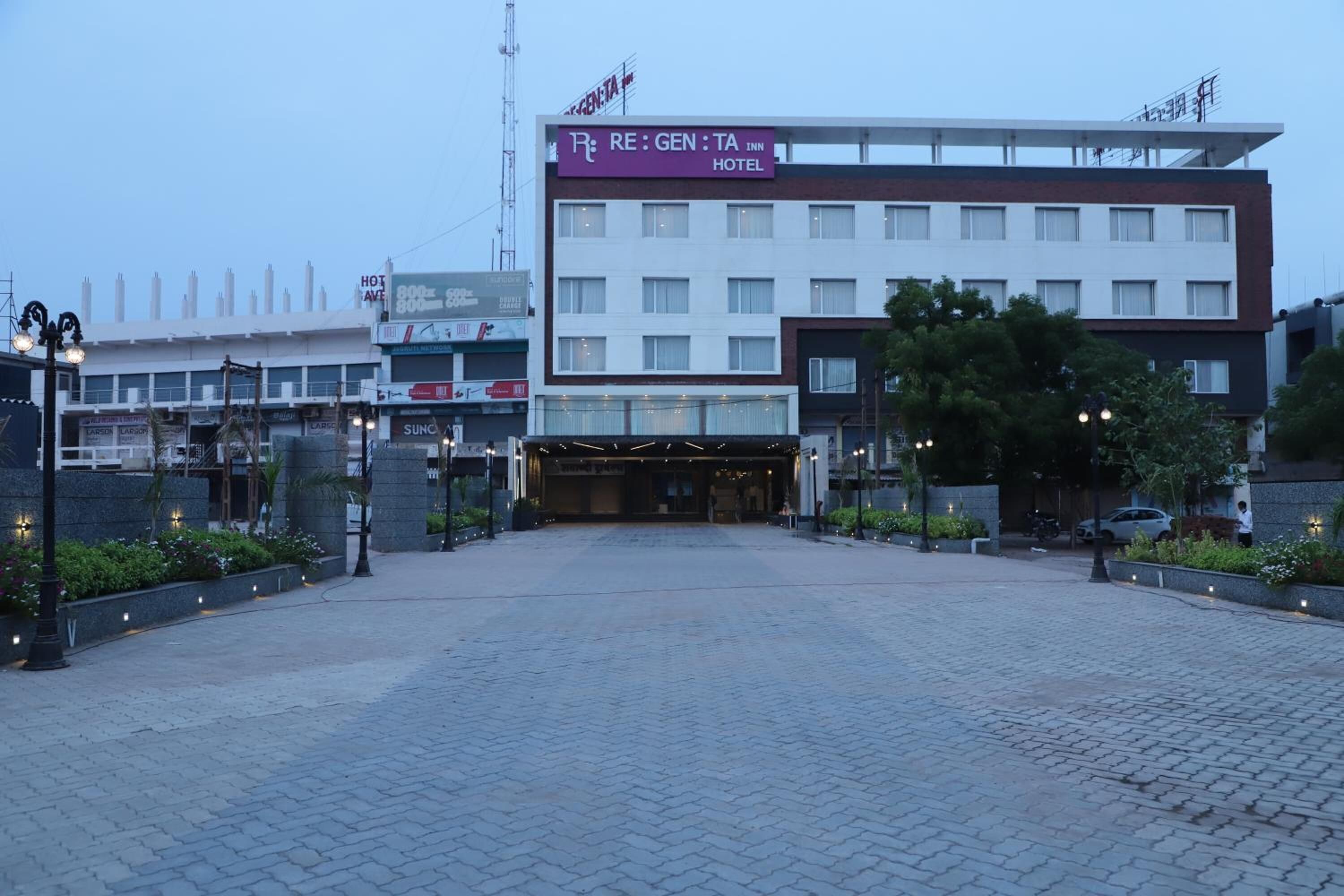 A hotel entrance with a sign for RE:GEN:TA Inn Hotel.