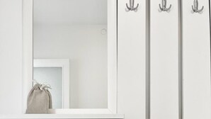 A white wardrobe with two doors and a mirror above. - Lemon Tree Apartments (Zadar)