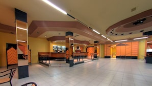 A spacious lobby with a bar area, seating, and a staircase. - Hotel Avenida (Beas de Segura)