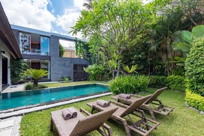 A modern house with a swimming pool, outdoor furniture, and lush greenery. - Beautiful Villa With Private Pool, Bali Villa 2028 (Seminyak)